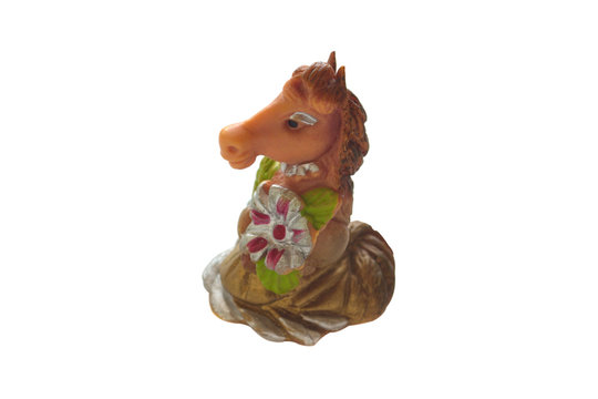 Decorative figure of a rubber horse in a dress isolated on a white background