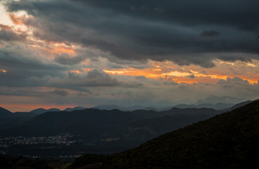Obraz premium dramatic sunset with storm approching in mountains of dominican republic