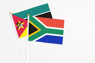 South Africa and Mozambique stick flags on white background. High quality fabric, miniature national flag. Peaceful global concept.White floor for copy space.