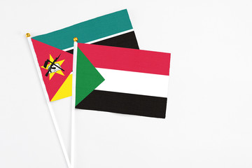 Sudan and Mozambique stick flags on white background. High quality fabric, miniature national flag....