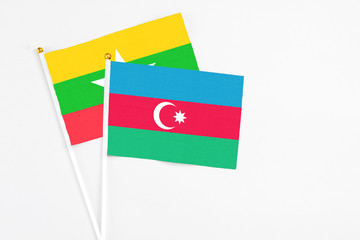 Azerbaijan and Myanmar stick flags on white background. High quality fabric, miniature national flag. Peaceful global concept.White floor for copy space.