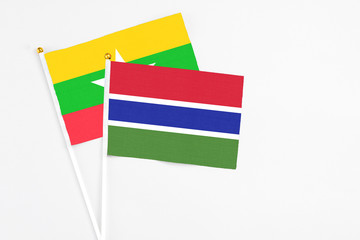 Gambia and Myanmar stick flags on white background. High quality fabric, miniature national flag. Peaceful global concept.White floor for copy space.