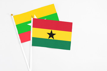 Ghana and Myanmar stick flags on white background. High quality fabric, miniature national flag. Peaceful global concept.White floor for copy space.