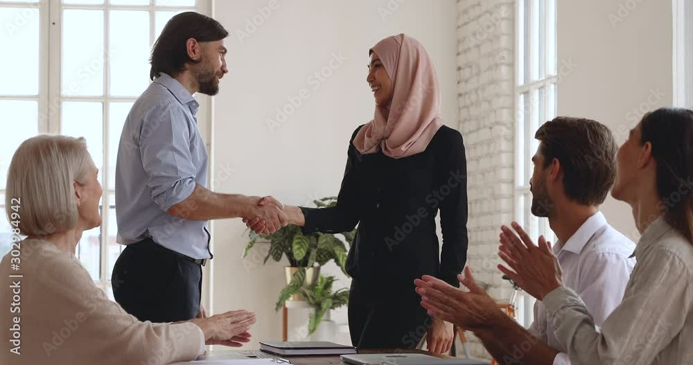 Sticker Male boss handshake promote female asian muslim worker, reward concept