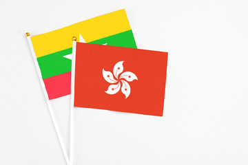 Hong Kong and Myanmar stick flags on white background. High quality fabric, miniature national flag. Peaceful global concept.White floor for copy space.