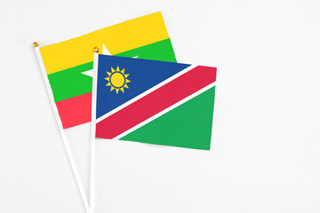 Namibia and Myanmar stick flags on white background. High quality fabric, miniature national flag. Peaceful global concept.White floor for copy space.