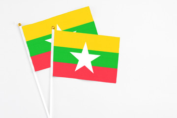 Myanmar and Myanmar stick flags on white background. High quality fabric, miniature national flag. Peaceful global concept.White floor for copy space.