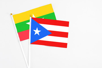 Puerto Rico and Myanmar stick flags on white background. High quality fabric, miniature national flag. Peaceful global concept.White floor for copy space.