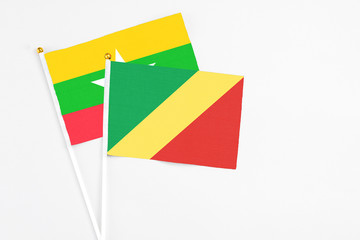 Republic Of The Congo and Myanmar stick flags on white background. High quality fabric, miniature national flag. Peaceful global concept.White floor for copy space.