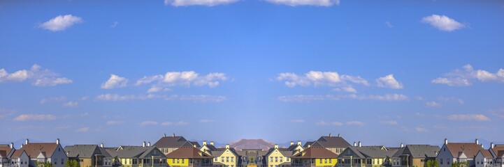 Colorful homes with symmetrical layout in a community with blue skies