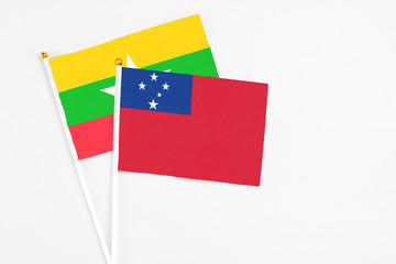 Samoa and Myanmar stick flags on white background. High quality fabric, miniature national flag. Peaceful global concept.White floor for copy space.