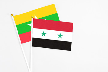 Syria and Myanmar stick flags on white background. High quality fabric, miniature national flag. Peaceful global concept.White floor for copy space.