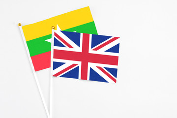 United Kingdom and Myanmar stick flags on white background. High quality fabric, miniature national flag. Peaceful global concept.White floor for copy space.