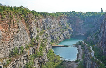 Blue lake at a bottom of a quarry