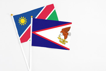 American Samoa and Namibia stick flags on white background. High quality fabric, miniature national...