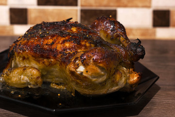 Chicken on a black plate. Thanksgiving Day.