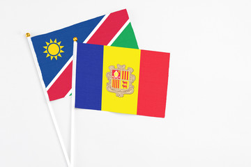 Andorra and Namibia stick flags on white background. High quality fabric, miniature national flag. Peaceful global concept.White floor for copy space.