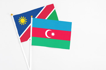 Azerbaijan and Namibia stick flags on white background. High quality fabric, miniature national flag. Peaceful global concept.White floor for copy space.
