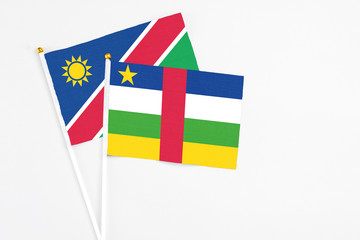 Central African Republic and Namibia stick flags on white background. High quality fabric, miniature national flag. Peaceful global concept.White floor for copy space.