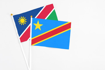 Congo and Namibia stick flags on white background. High quality fabric, miniature national flag. Peaceful global concept.White floor for copy space.