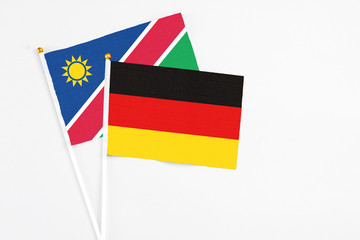 Germany and Namibia stick flags on white background. High quality fabric, miniature national flag. Peaceful global concept.White floor for copy space.