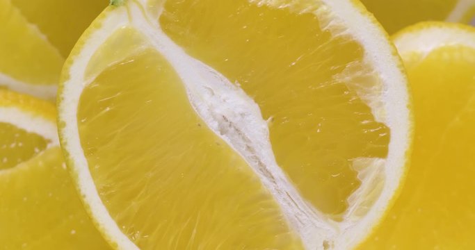 Fresh sliced orange rotating on white surface. Close up of vitamin detox fruit.  4k food isolated.