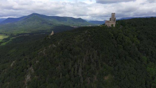 Rising aerial shot approaching ancient castle in France on a cloudy day. Shot end closing to the castle
