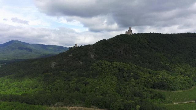 Rising aerial shot approaching two ancient castle in France on a cloudy day