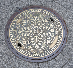 Decorated manhole cover downtown in Budapest, capital city Hungary