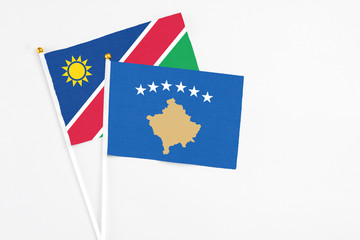 Kosovo and Namibia stick flags on white background. High quality fabric, miniature national flag. Peaceful global concept.White floor for copy space.
