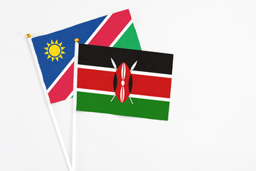 Kenya and Namibia stick flags on white background. High quality fabric, miniature national flag. Peaceful global concept.White floor for copy space.