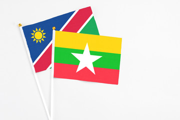 Myanmar and Namibia stick flags on white background. High quality fabric, miniature national flag. Peaceful global concept.White floor for copy space.