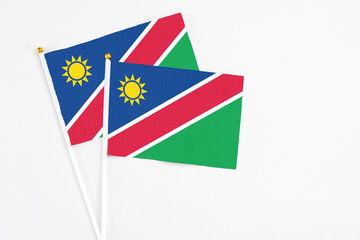 Namibia and Namibia stick flags on white background. High quality fabric, miniature national flag. Peaceful global concept.White floor for copy space.