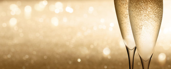 Champagne glasses on golden background