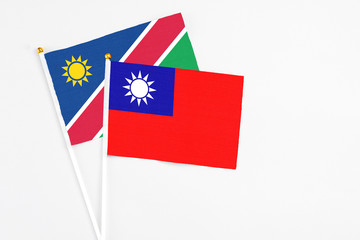 Taiwan and Namibia stick flags on white background. High quality fabric, miniature national flag. Peaceful global concept.White floor for copy space.
