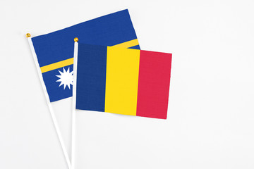 Chad and Nauru stick flags on white background. High quality fabric, miniature national flag. Peaceful global concept.White floor for copy space.