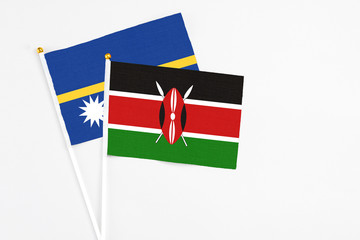 Kenya and Nauru stick flags on white background. High quality fabric, miniature national flag. Peaceful global concept.White floor for copy space.