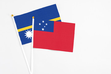Samoa and Nauru stick flags on white background. High quality fabric, miniature national flag. Peaceful global concept.White floor for copy space.