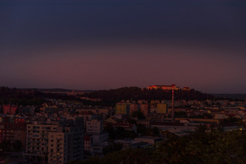 Castle Spilberk time-lapse captured in wide before sunset and castle turn on red light view in Brno city streets with building and surround area.