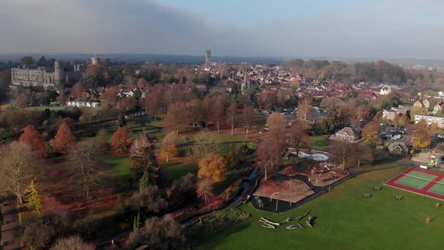 Warwick Town Aerial Drone View Of Park, River Avon, Churches And Castle In Autumn On Cloudy Day, Camera Panning Left