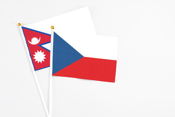 Czech Republic and Nepal stick flags on white background. High quality fabric, miniature national flag. Peaceful global concept.White floor for copy space.