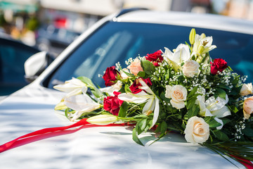 Wedding car fresh flower decoration. Red and white fresh flowers