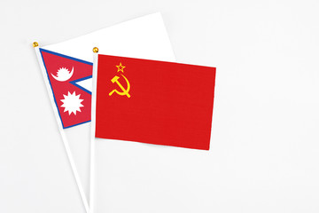 Soviet Union and Nepal stick flags on white background. High quality fabric, miniature national flag. Peaceful global concept.White floor for copy space.