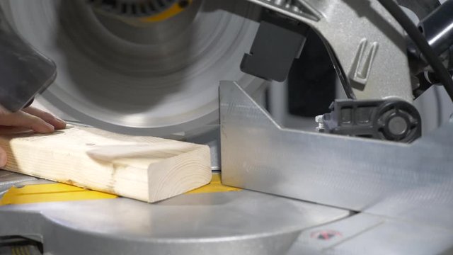 Using a power saw to make a miter cut on a 2x4 - side1