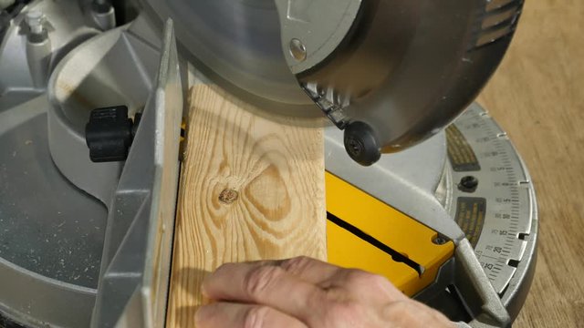 Using a power saw to do a miter cut on a 2x4-side2