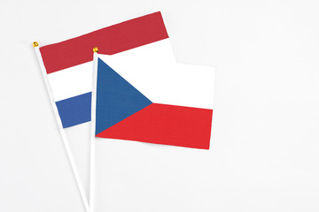 Czech Republic and Netherlands stick flags on white background. High quality fabric, miniature national flag. Peaceful global concept.White floor for copy space.