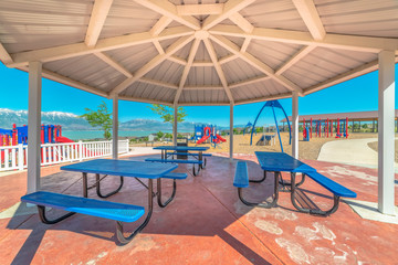 Octagon pavilion with blue picnic tables and view of lake and Mount Timpanogos
