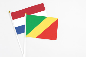 Republic Of The Congo and Netherlands stick flags on white background. High quality fabric, miniature national flag. Peaceful global concept.White floor for copy space.