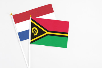 Vanuatu and Netherlands stick flags on white background. High quality fabric, miniature national...