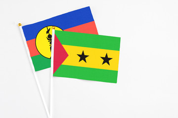 Sao Tome And Principe and New Caledonia stick flags on white background. High quality fabric,...